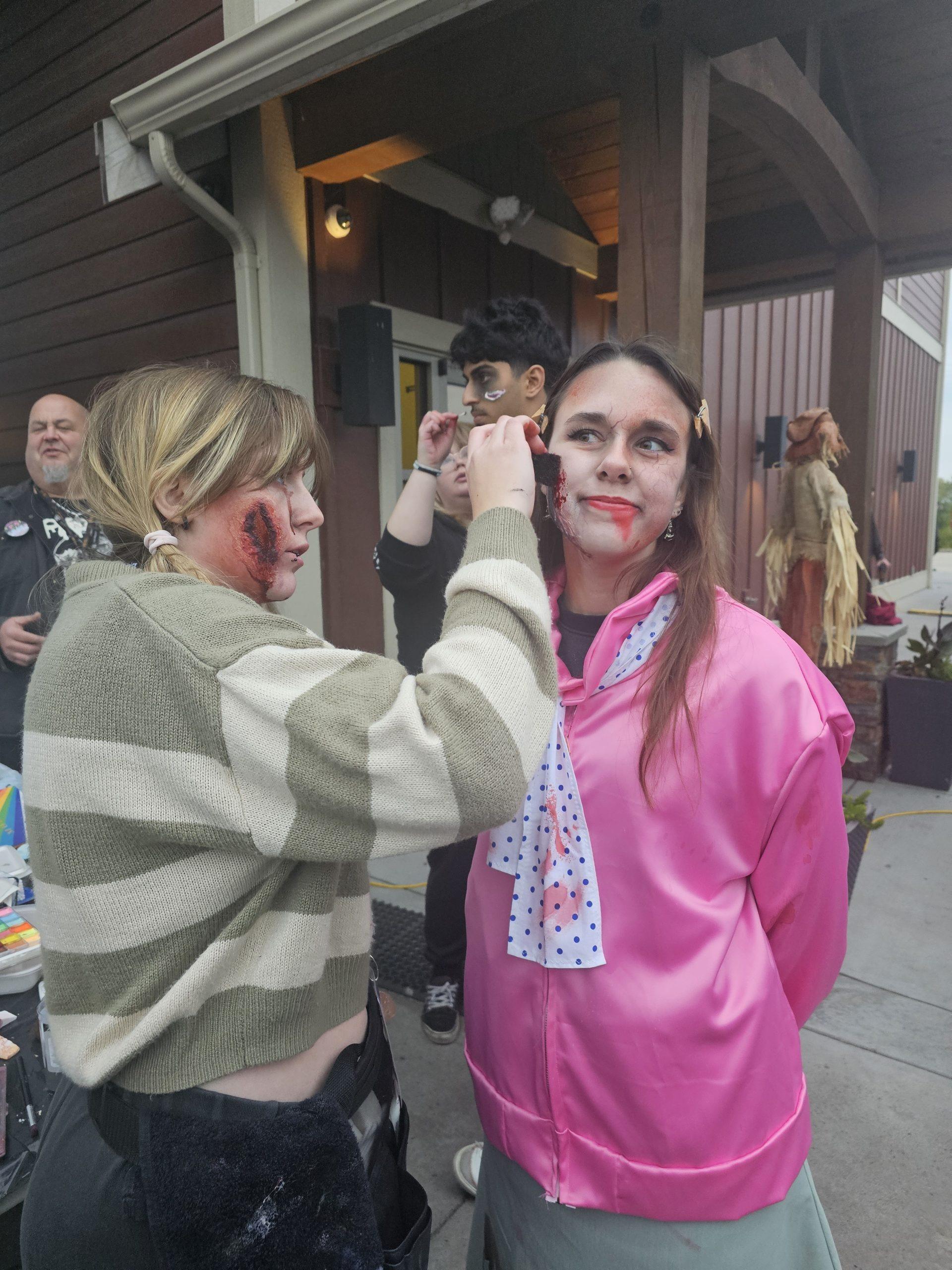 A volunteer getting their scare makeup applied